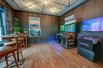 A room with a wooden floor and a wall with a picture of a boat on it.